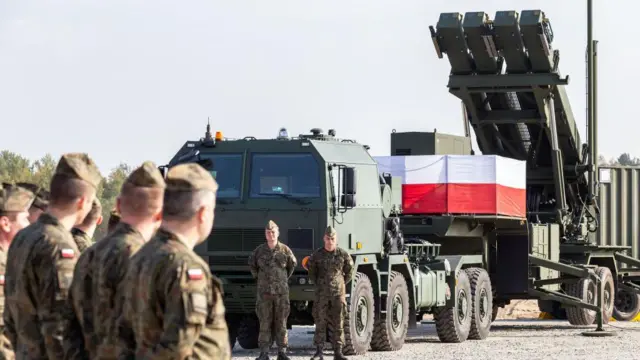 Польські військові біля пускової установки Patriot з прапором Польщі